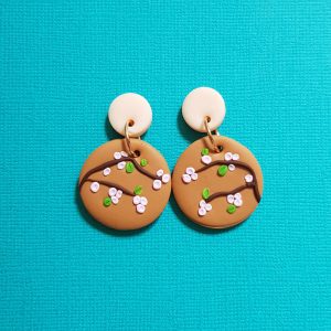 Cherry Blossom earrings handmade from polymer clay pink blossom on tan background