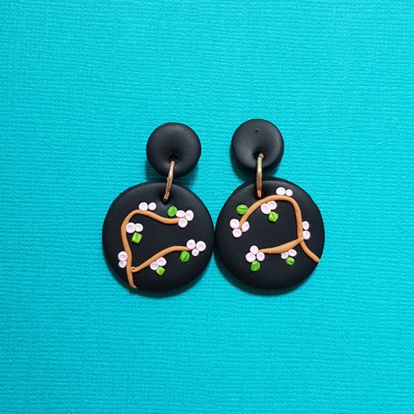 Cherry Blossom earrings handmade from polymer clay pink blossom on black background