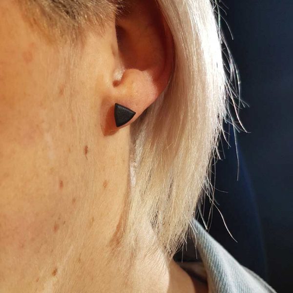 Model wearing triangle earrings